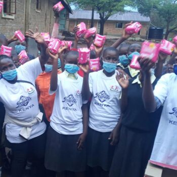 Masked schoolgirls holding pink packages